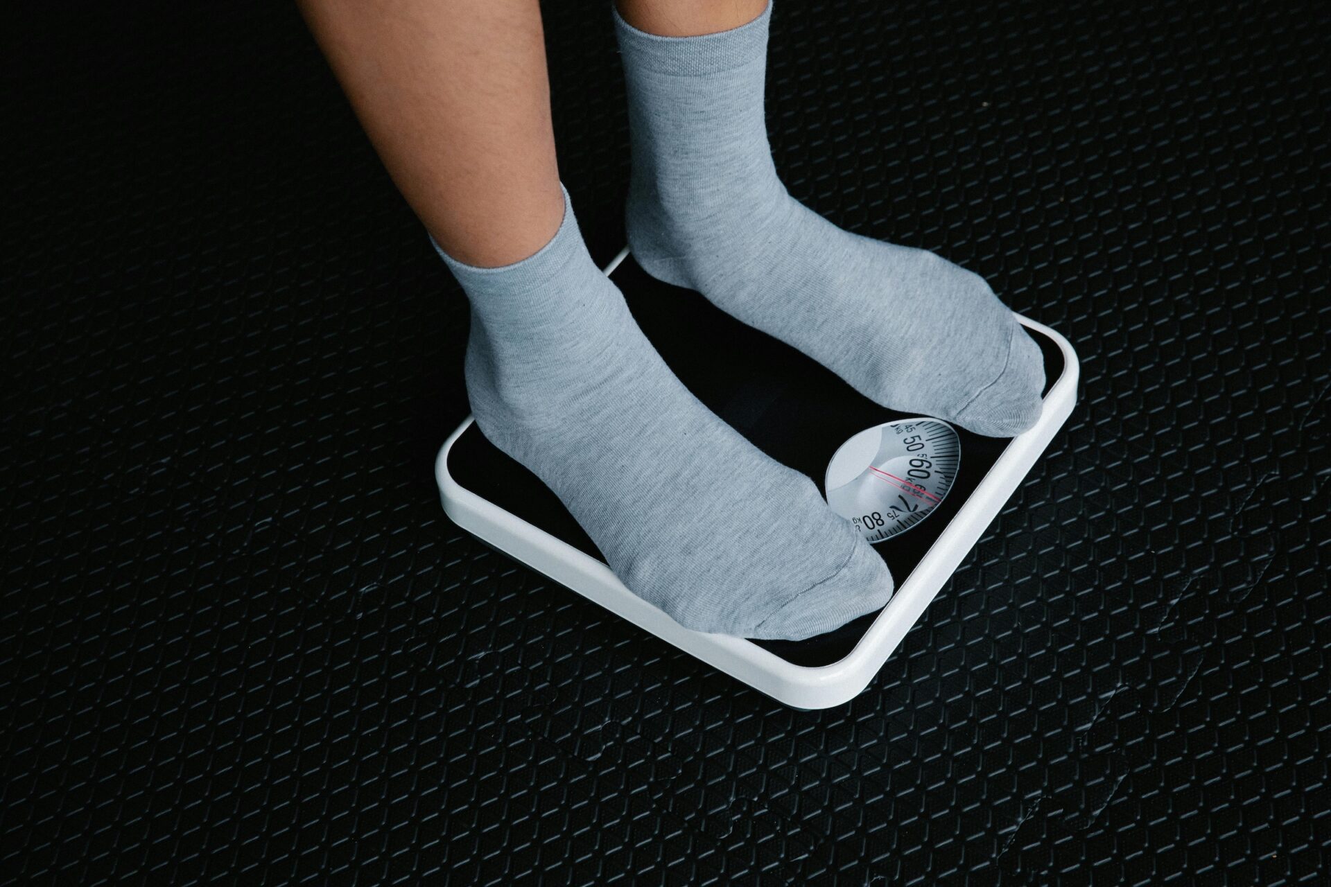 Person standing on weight scale for cyclists making race weight