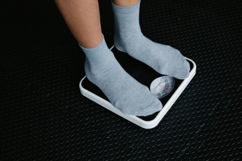Person standing on weight scale for cyclists making race weight