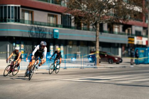 three cyclists on a turn in an urban race