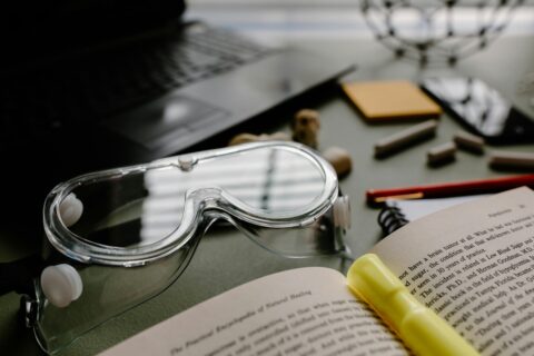 Scientific research book with goggles and utensils for sports science