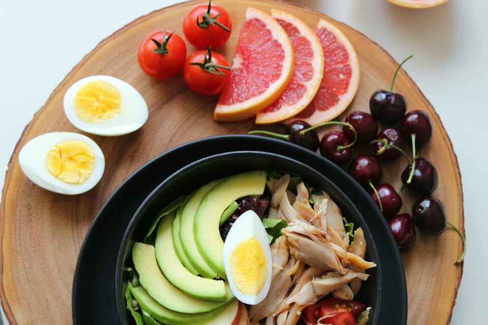 healthy meal including eggs, grapes, and tomatoes