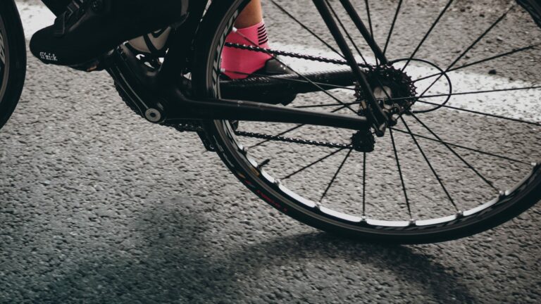 Close up shot of cycling shoes on the bike shot through the back tire