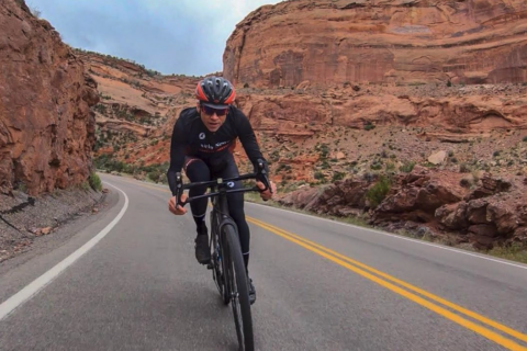 Chris Case pedaling a bike through a canyon