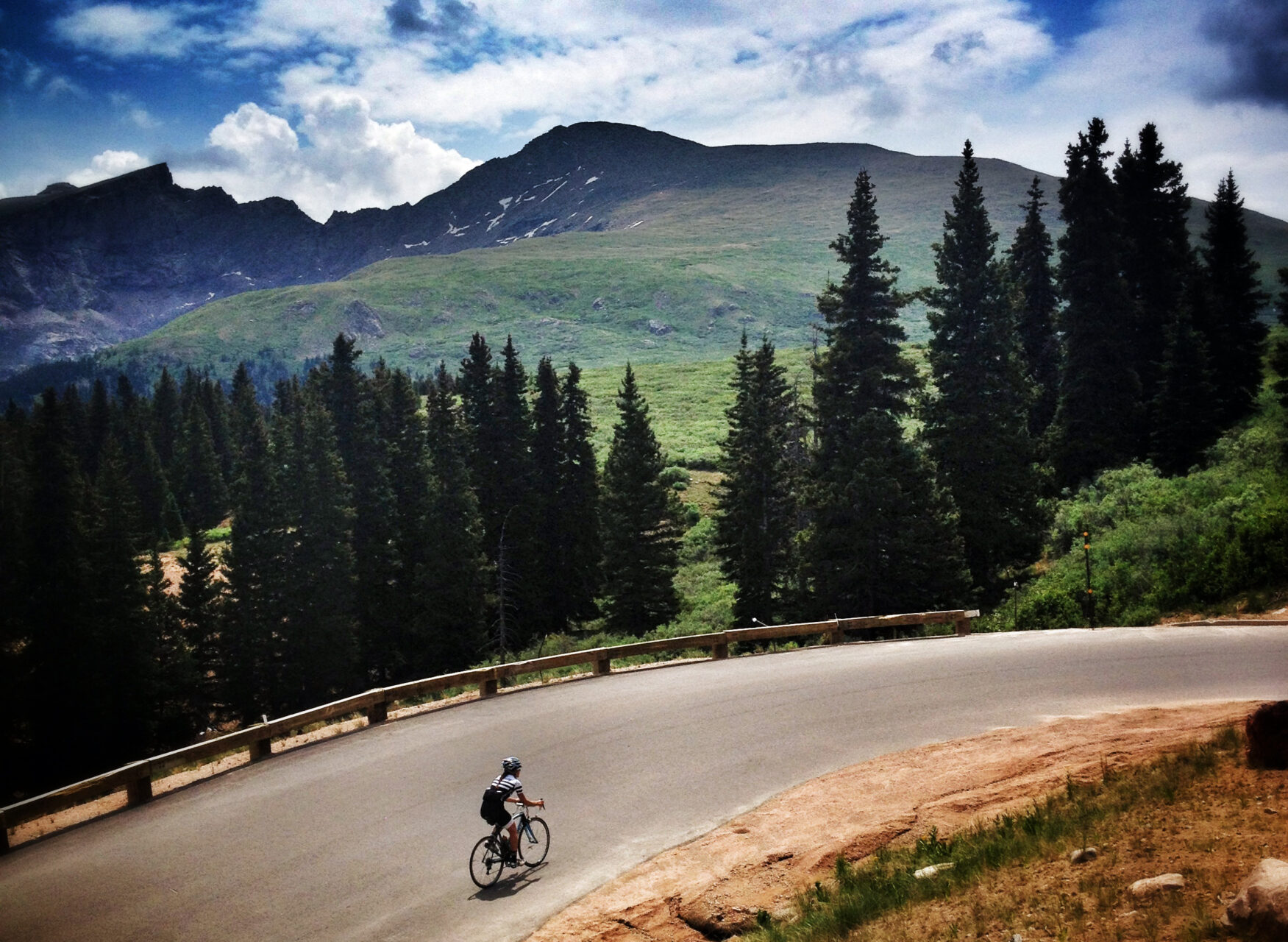 cyclist climbing by bike on Guanella Pass Colorado