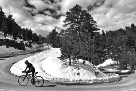 cyclist climbs Flagstaff Mountain in the snow