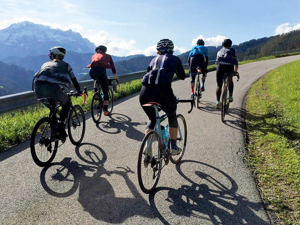 Cyclists riding in the Dolomites by Chris Case