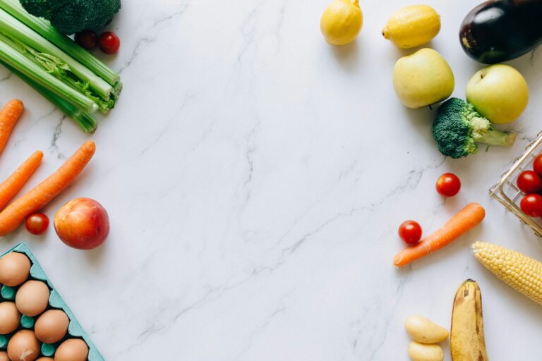 Assorted fruits and vegetables on marble table for sports nutrition