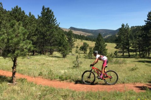 A mountain biker rides a trail at Joder Ranch