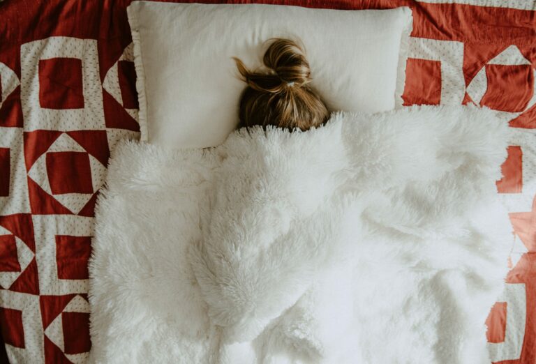 Woman-Sick-in-Bed-Under-Covers-Ways-to-Cope-with-Sickness