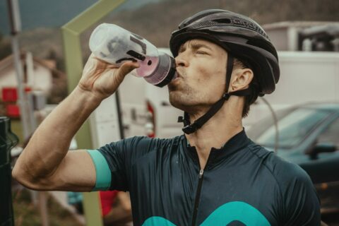 cyclist drinks from water bottle