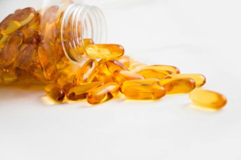 Yellow capsules on table for athletic supplement responsibility
