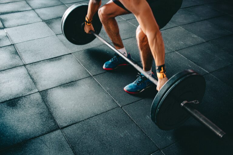 athlete squatting in gym for strength functional training
