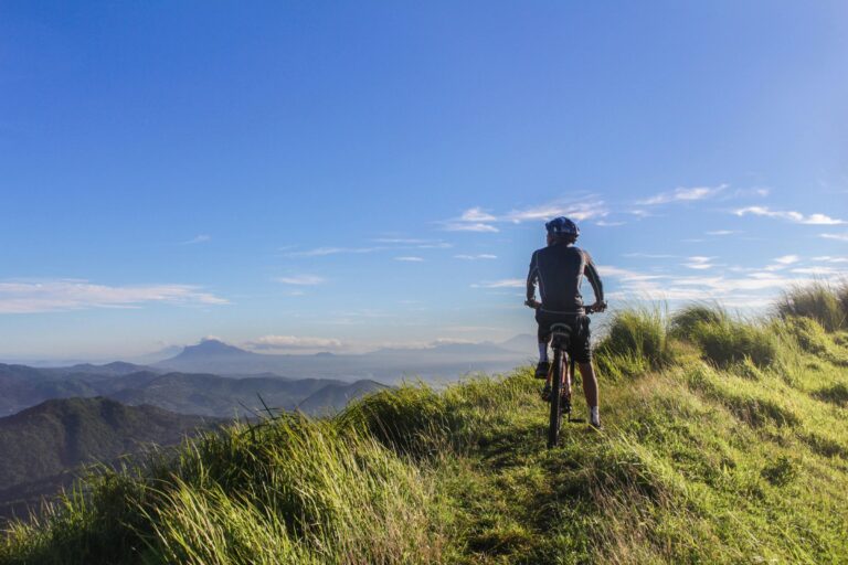 Cyclist on top of mountain view for false cycling beliefs