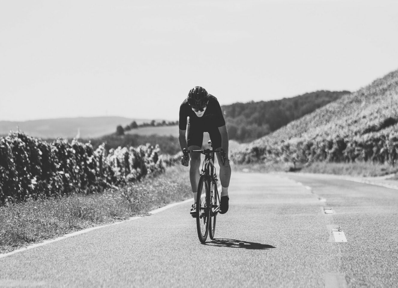 Lone cyclist training on empty road