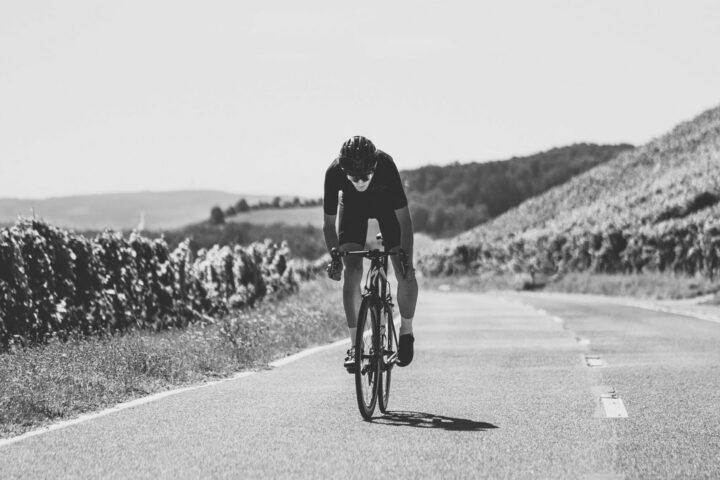 Lone cyclist training on empty road