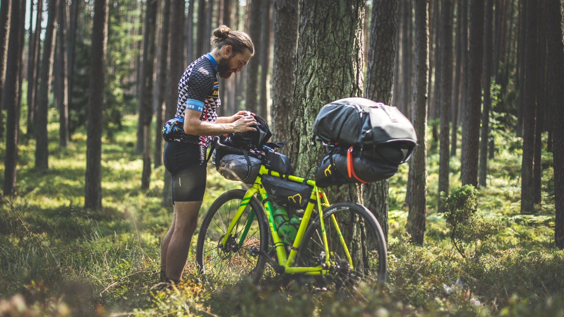 Bikepacker securing his gear before starting his ride