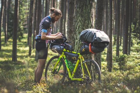 Bikepacker securing his gear before starting his ride