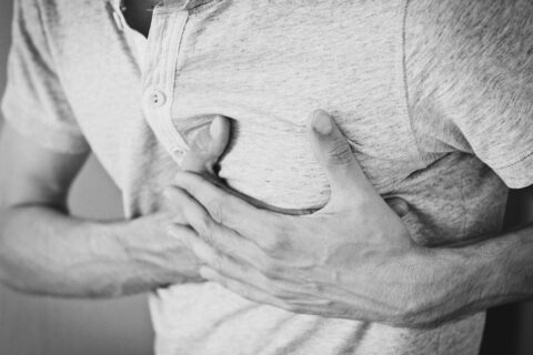 man clutching chest