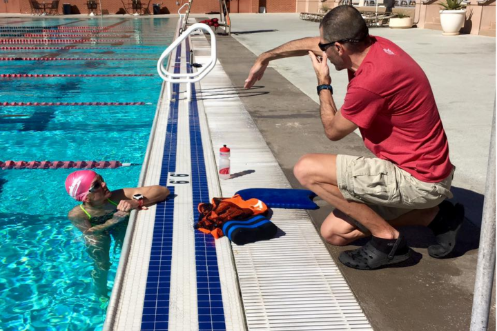 Coach Alan Couzens teaches a swimmer