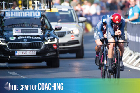photo of time trialist with team car following