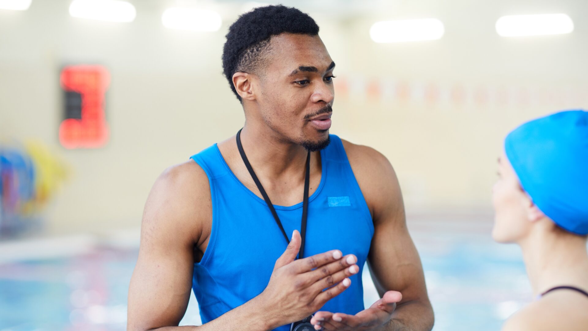 A swim coach speaking to his athlete