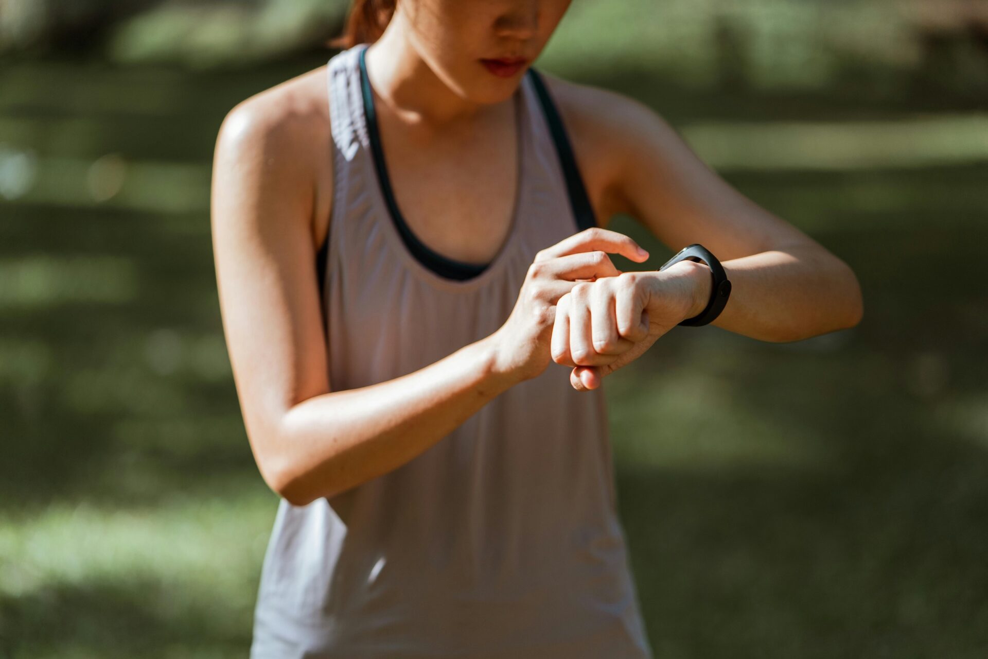Runner stopping run to check VO2 Max on smart watch heart rate monitor