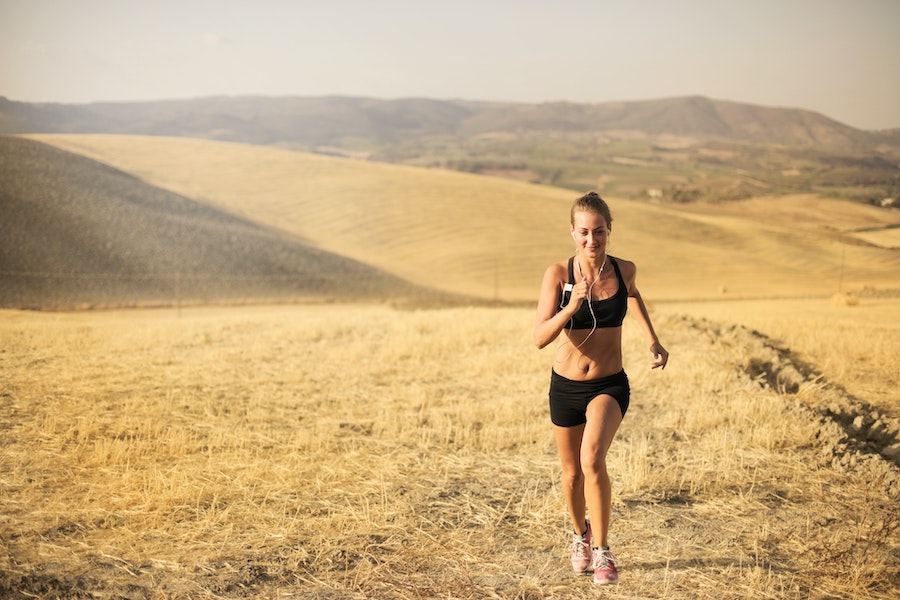 woman trail running in the mountains