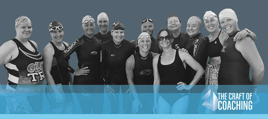 Group of female triathletes smiling in their swim gear