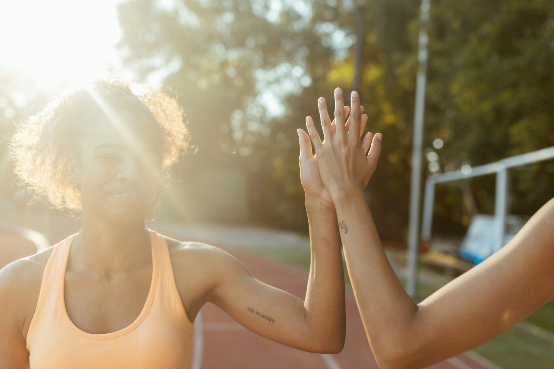 Runner getting a high five from coach to stoke motivation