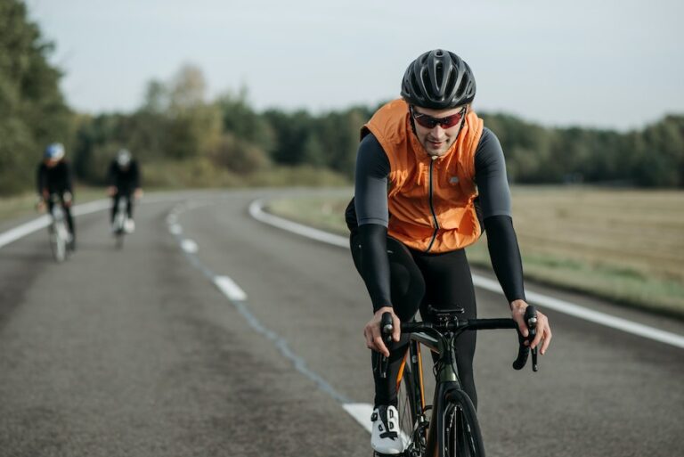 Lone biker in an orange vest