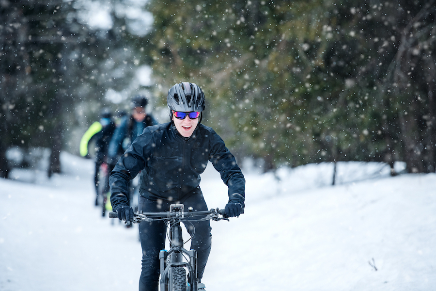 cyclists riding in snow