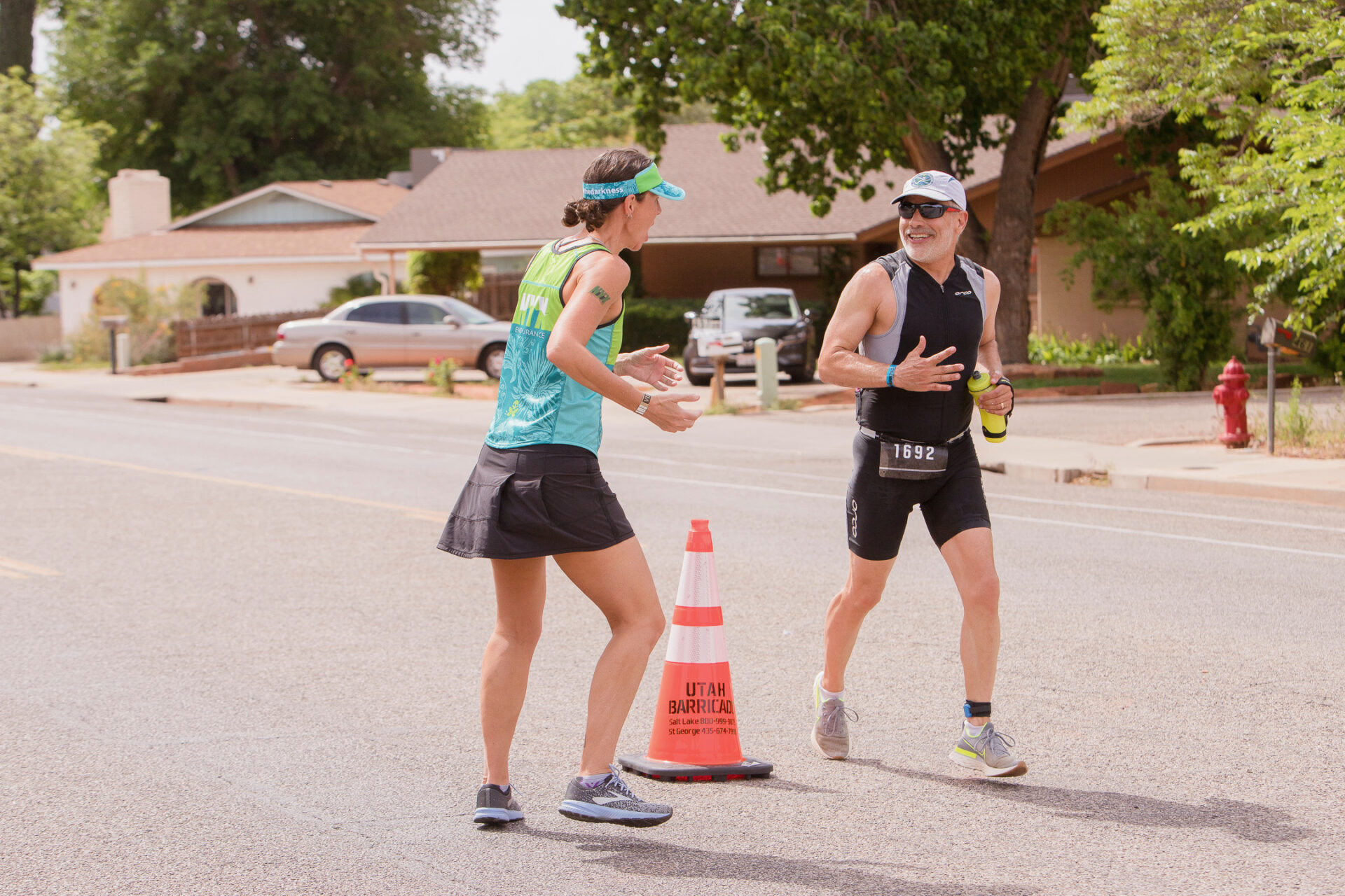 Female coach encouraging an age group athlete at a local race