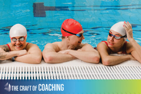 photo of swimmers talking on the pool deck