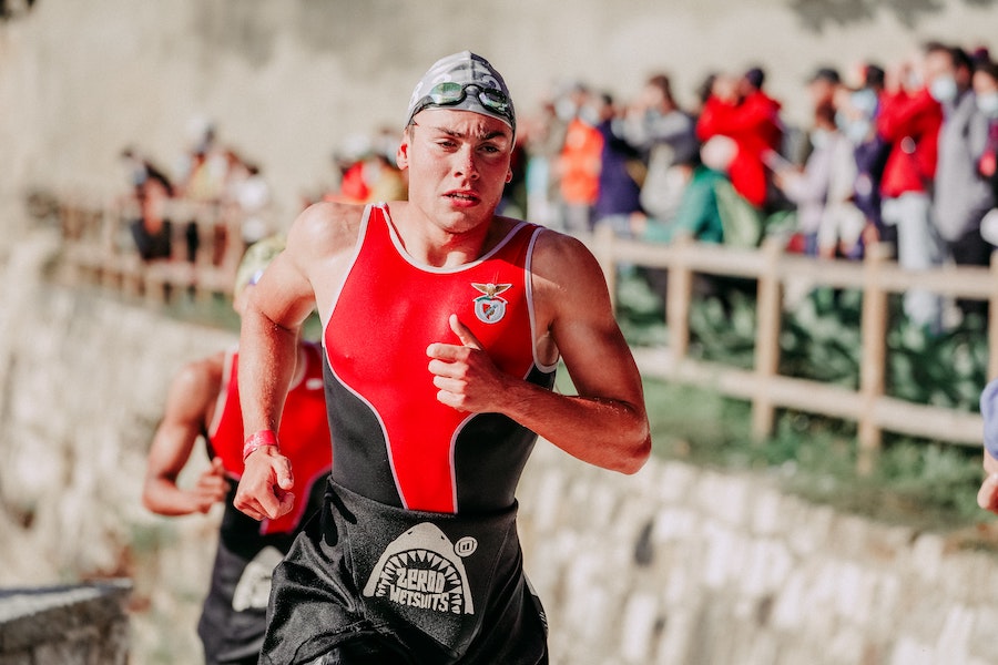 Male triathlete exiting the swim portion of a race