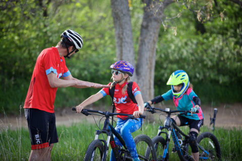 photo of Pete Webber coaching two young athletes