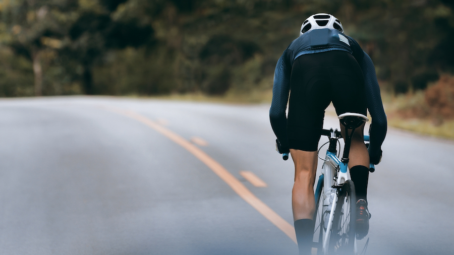 cyclist riding hard uphill