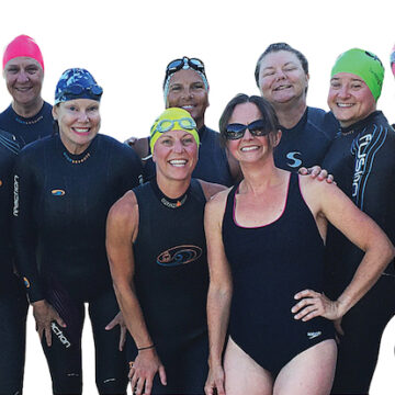 Triathlon ladies standing in a group in wetsuits