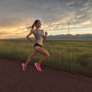 Female Runner running fast with sunset background