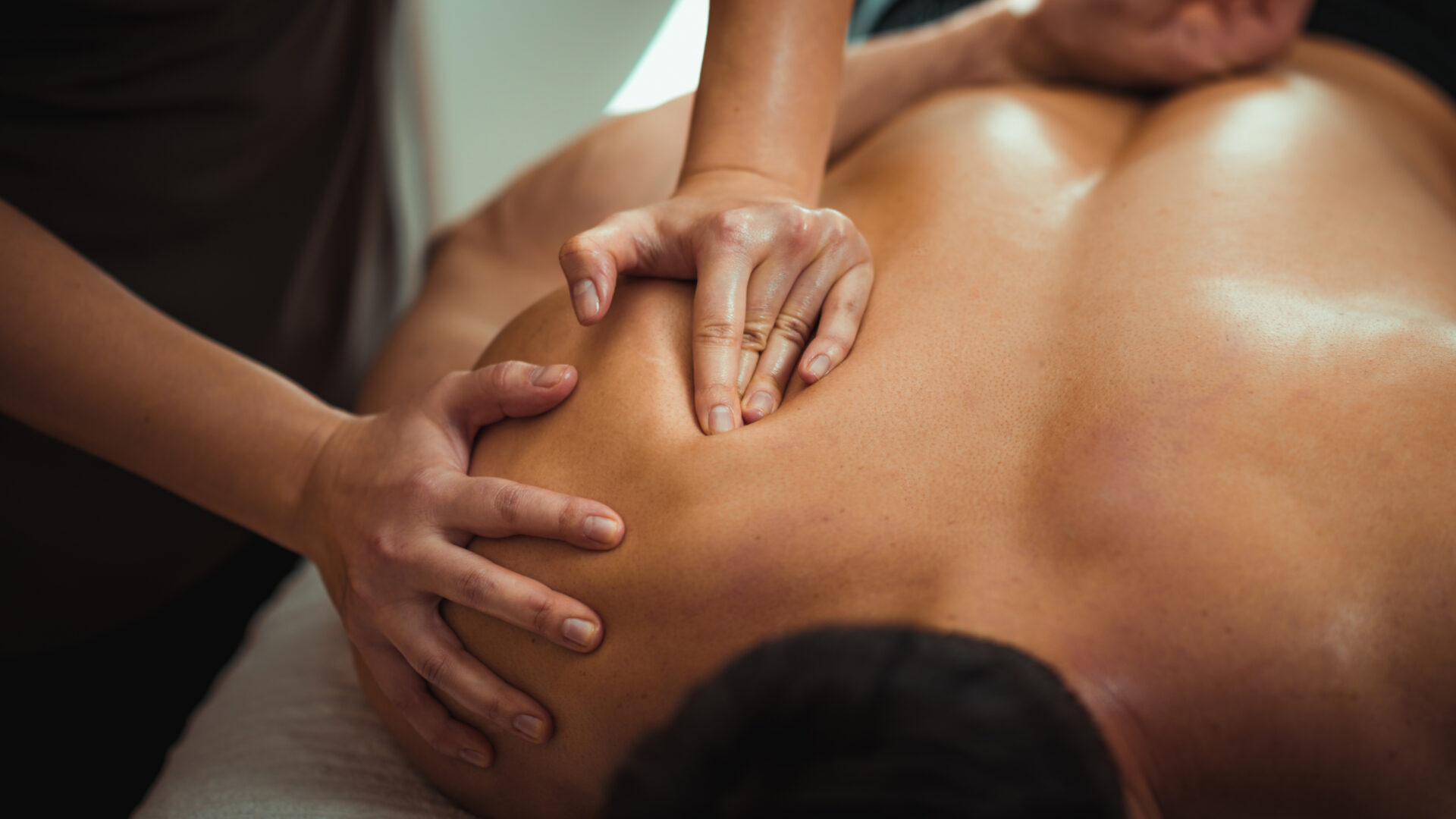 Close up of a man getting deep tissue massage, a type of manual therapy