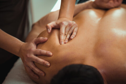 Close up of a man getting deep tissue massage, a type of manual therapy
