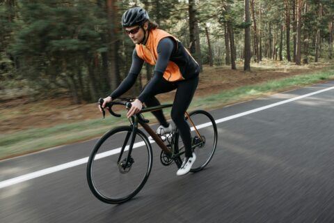 Man riding a bike on the street.