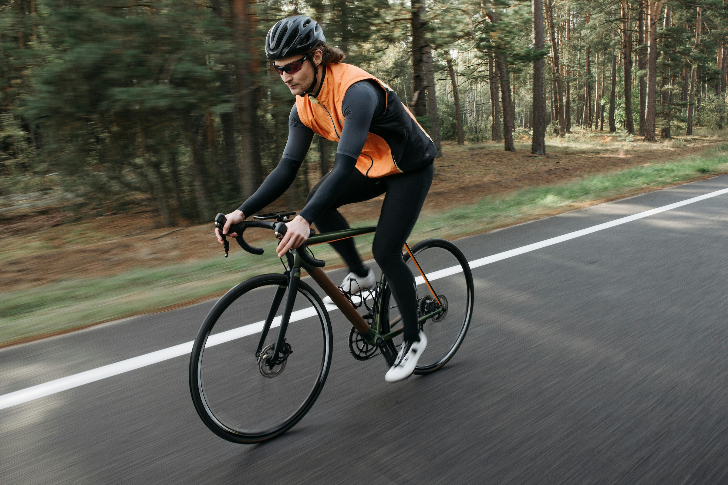 Man riding a bike on the street.