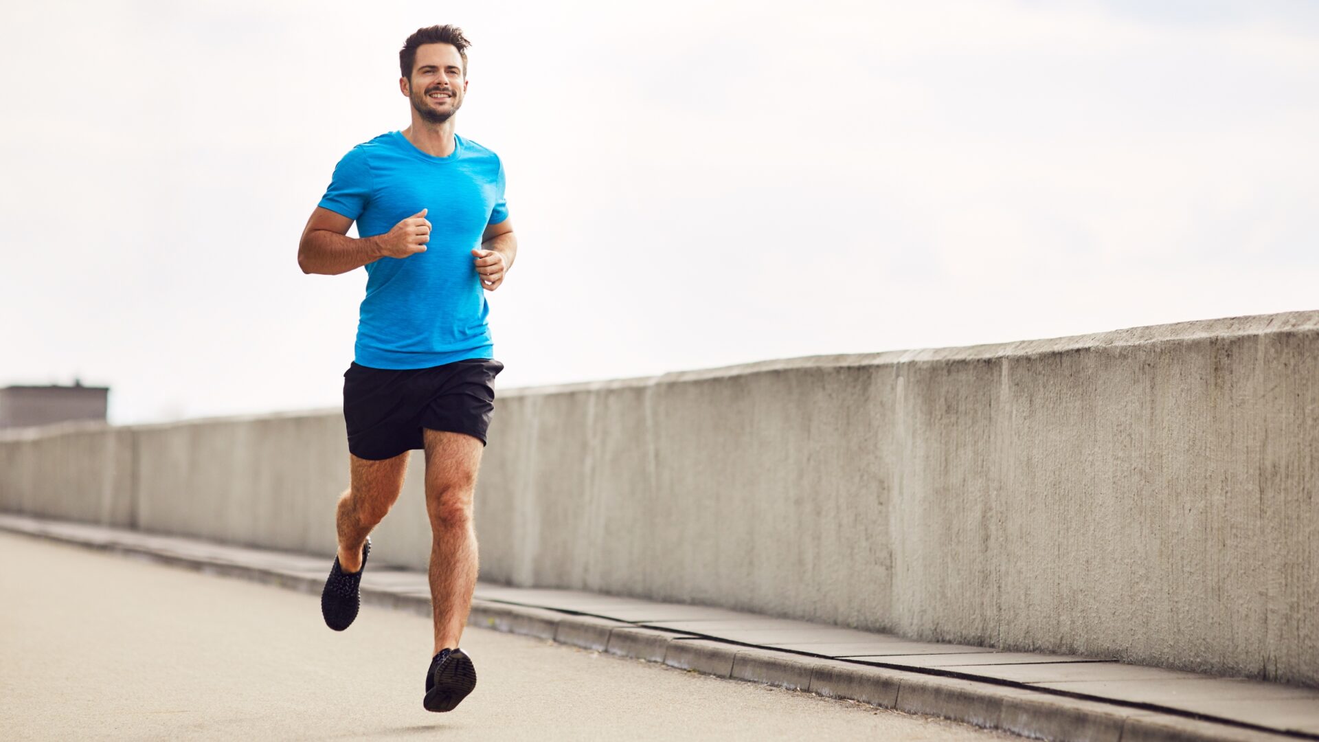 Man running along a bridge