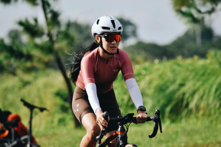 Women cyclist riding a bike down the street.