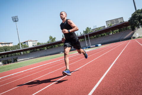 Man running micro-intervals on an outdoor track