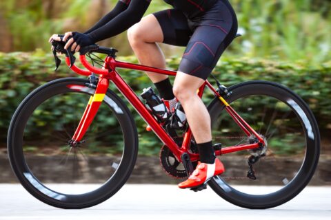 Lower section of a road cyclist riding their bike