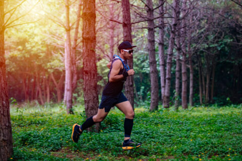 Ultra-endurance athlete running through the woods