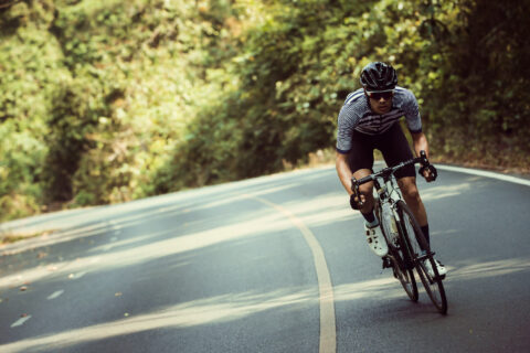 Man riding bike up a mountain road