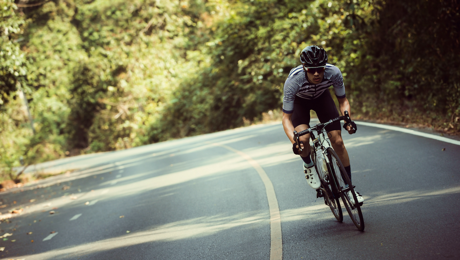 Man riding bike up a mountain road