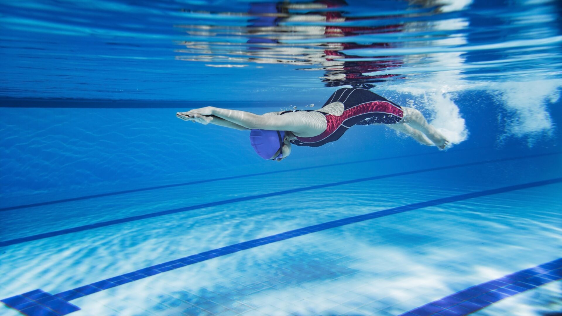 Underwater shot of a woman swimming laps in a pool